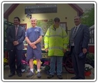 Carl Silvestrone stands in front of the old railway baggage cart that he restored with DPW colleague Paul Quatrale.