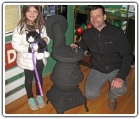 Martin Merva and his daughter Piper are seen with the restored B&M #1 potbelly stove that they donated to the Friends.